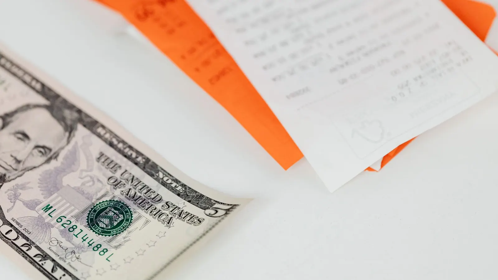 Bankovky a účtenky na stole.